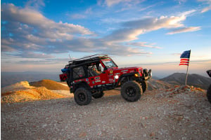 Metalcloak jeep TJ on a mountain with an american flag
