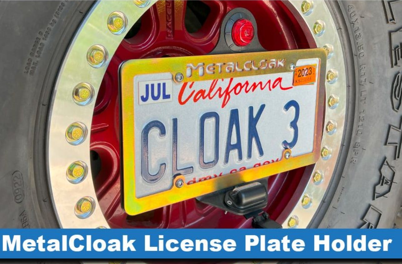 MetalCloak laser-cut license plate holder mounted on a beadlock wheel.